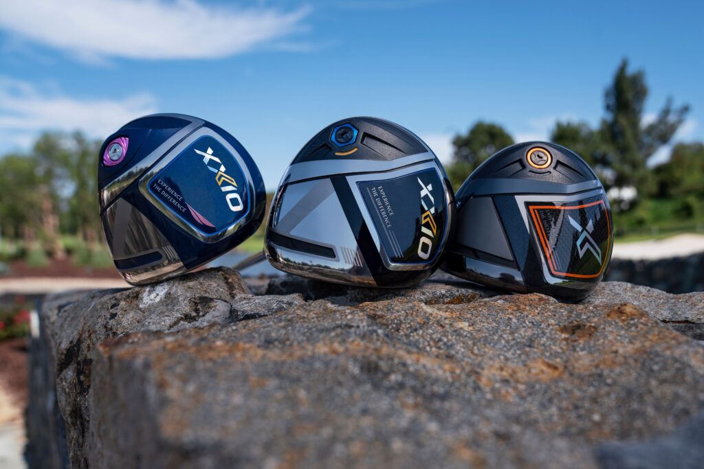 Three XXIO golf drivers on rocks.