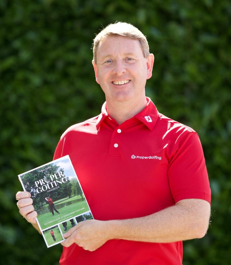 Man holding Proper Golfing handbook.