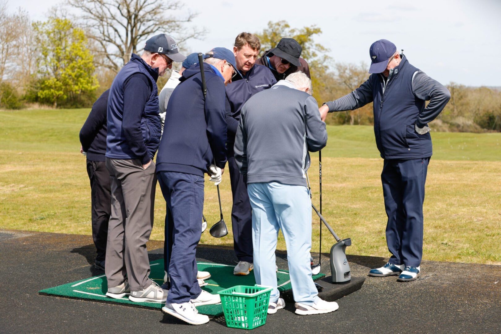 Group learning easy driver swing techniques on the range at The Oxfordshire