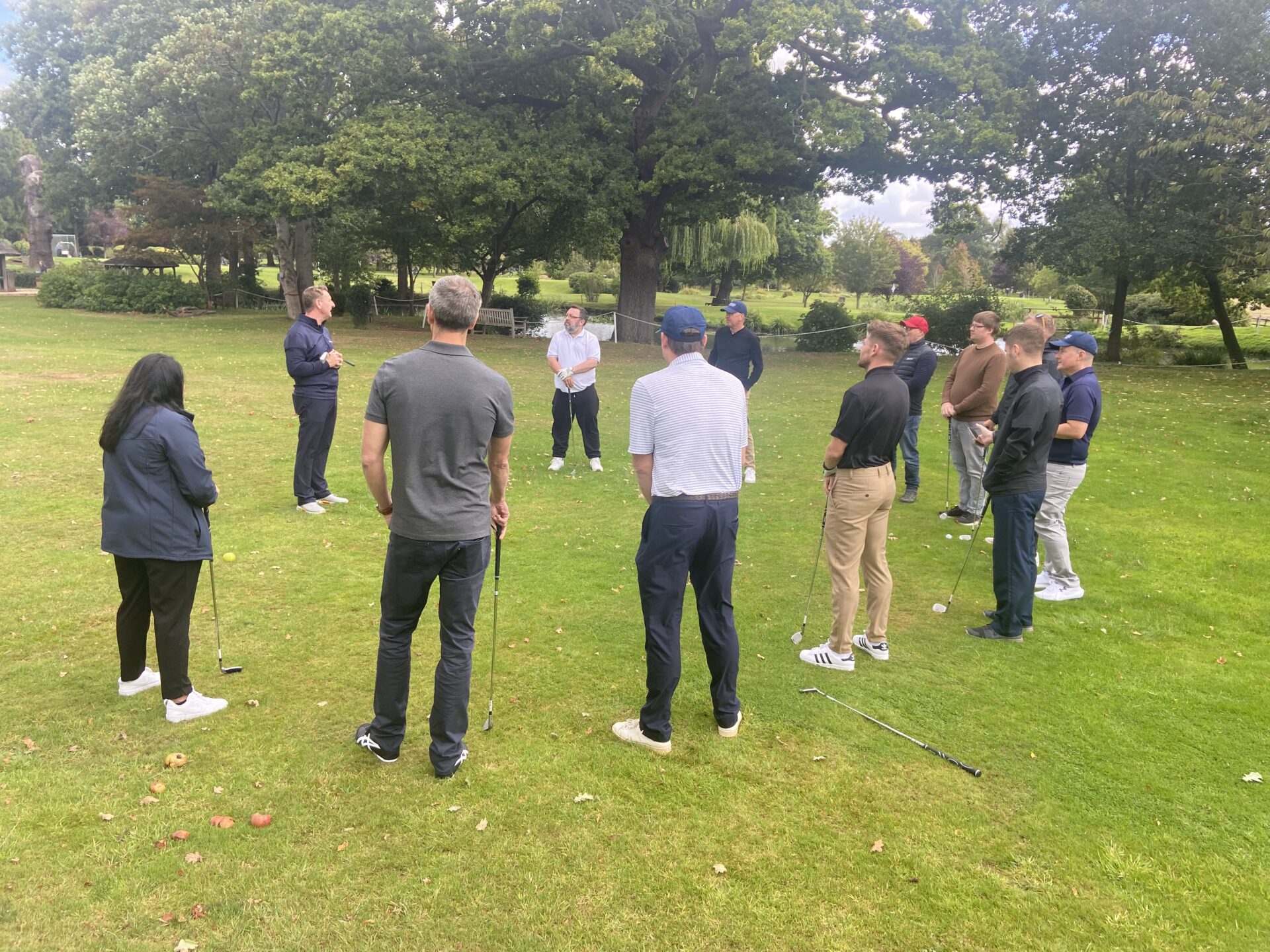 Corporate team gathered for golf coaching